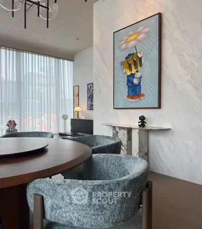Luxurious modern living room with stylish decor and large windows offering natural light.