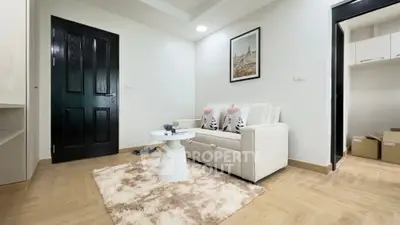 Cozy living room with modern decor and plush rug, perfect for relaxation.