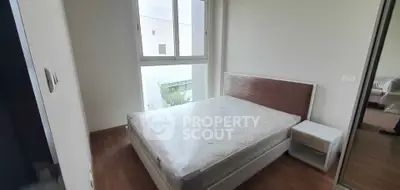 Cozy bedroom with large window and modern furnishings