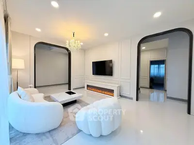 Luxurious modern living room with elegant chandelier and sleek fireplace