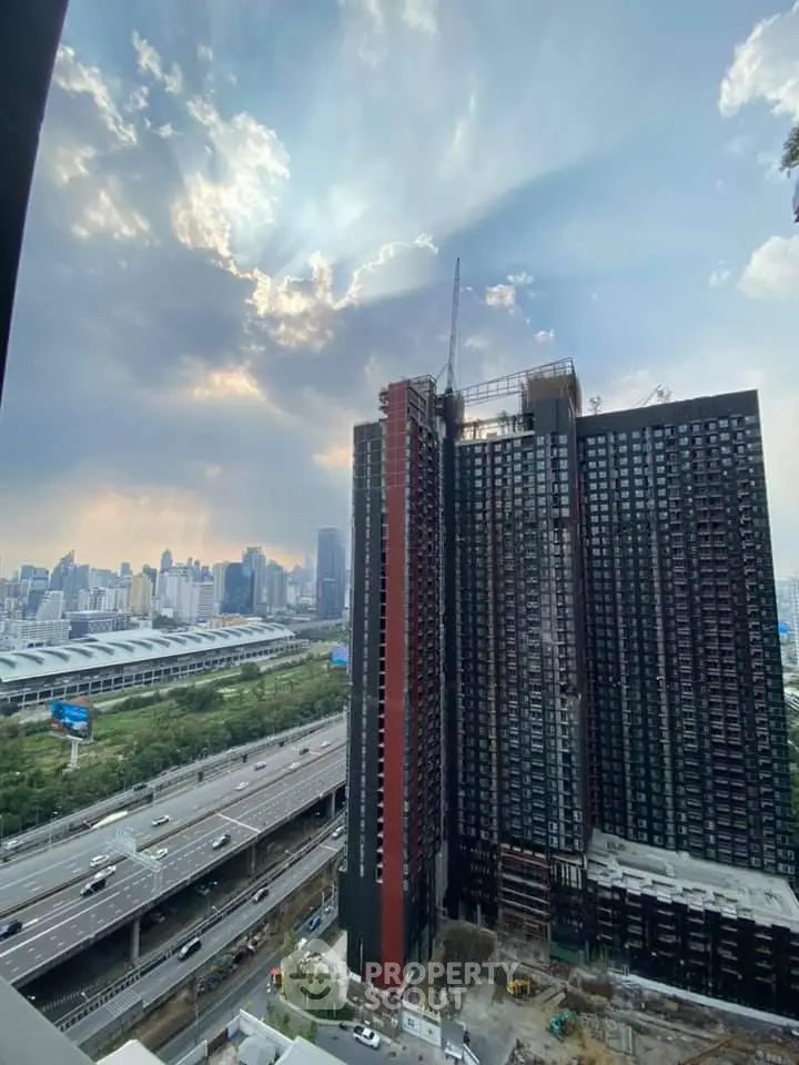 Stunning high-rise building with panoramic city view and highway access, perfect for urban living.