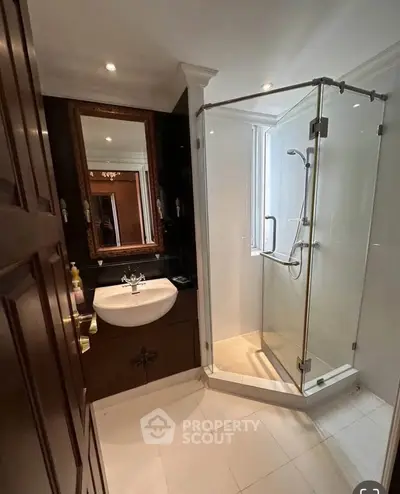 Elegant bathroom with glass shower and stylish vanity in modern home.