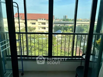 Charming balcony with city view, perfect for relaxation and enjoying the urban landscape.