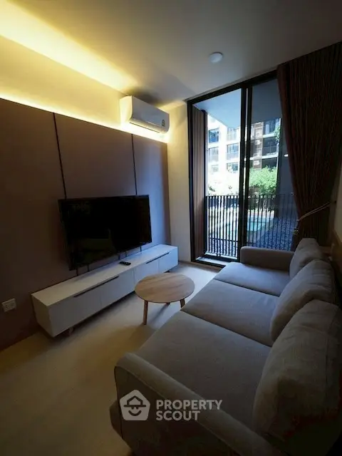 Modern living room with large window and cozy sofa in stylish apartment