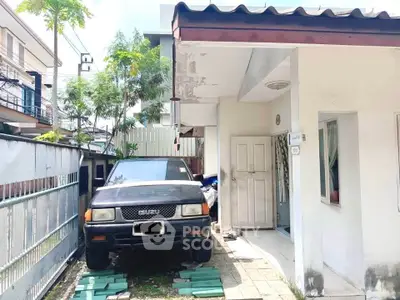 Charming suburban home with driveway and carport, perfect for family living.