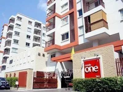 Modern condominium building exterior with stylish design and vibrant colors.
