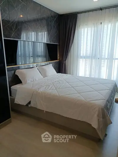 Modern bedroom with elegant decor and large window for natural light