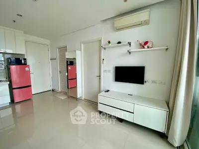 Modern living room with sleek furniture and vibrant red fridge, perfect for urban living.