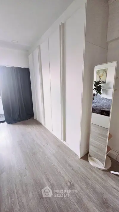 Spacious bedroom with sleek flooring and modern decor