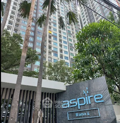 Modern high-rise building with lush greenery at Aspire Rama 4.