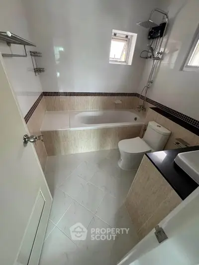 Modern bathroom with bathtub and sleek fixtures in a contemporary home.