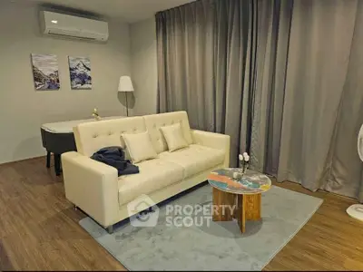 Modern living room with stylish beige sofa, elegant decor, and cozy ambiance.