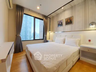 Spacious bedroom with city view in modern high-rise apartment