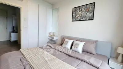 Cozy modern bedroom with stylish decor and cityscape artwork