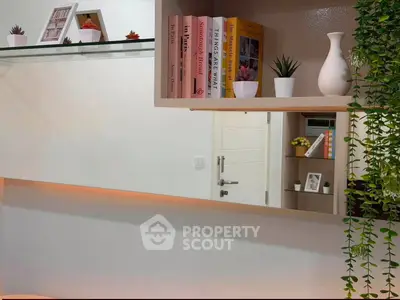 Modern interior with stylish shelving, decorative plants, and books creating a cozy ambiance.