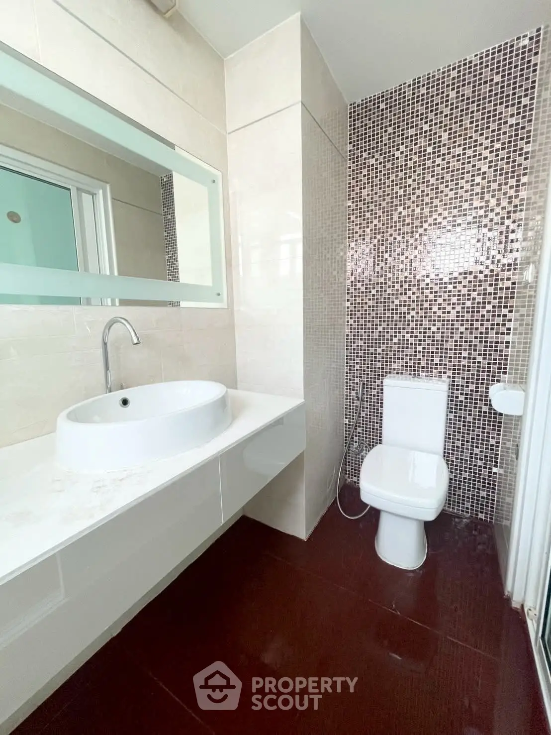 Modern bathroom with sleek sink and mosaic tile wall