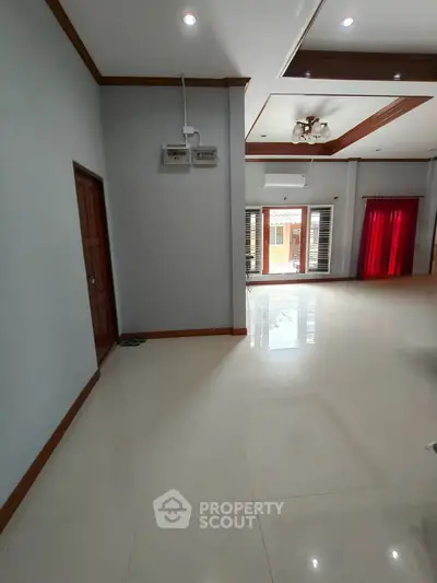 Spacious living room with modern design and large windows for natural light.