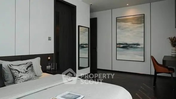 Modern bedroom with elegant decor and dark wood flooring