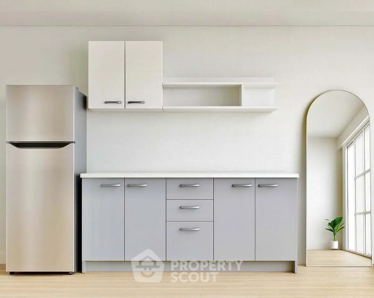 Modern kitchen with sleek cabinets and stainless steel fridge in bright minimalist design.