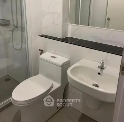 Modern bathroom with sleek fixtures and glass shower enclosure