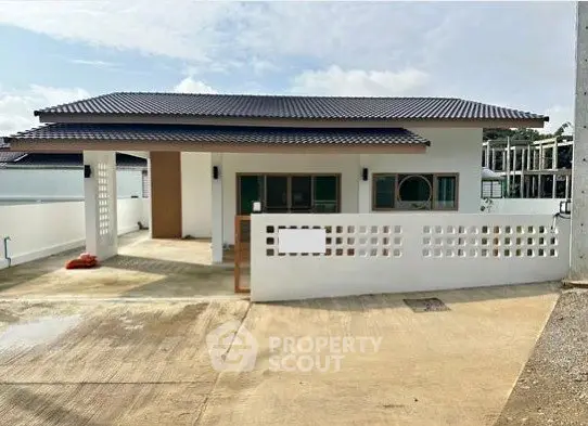 Charming single-story house with modern design and spacious driveway.