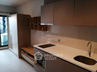 Modern kitchen with sleek cabinetry and built-in appliances in a stylish apartment.