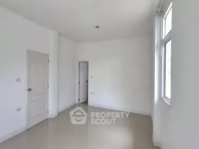 Spacious empty room with large windows and glossy tiled floor, perfect for customization.