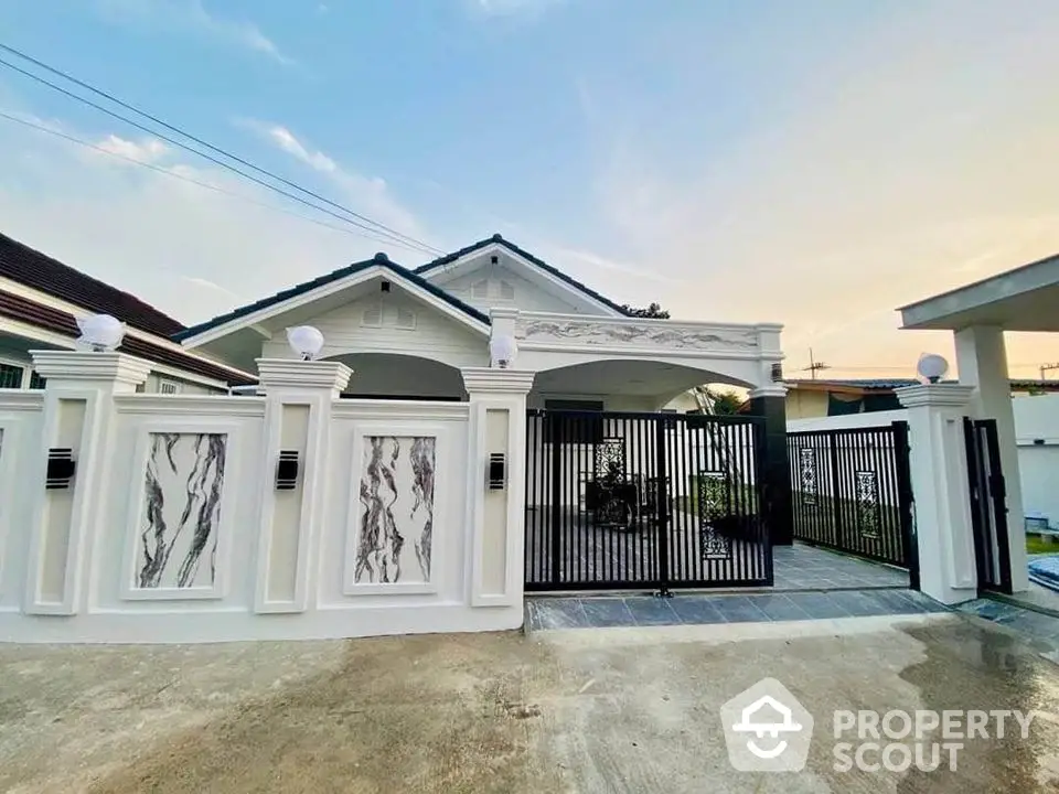 Charming single-story house with elegant gated entrance and stylish exterior design.