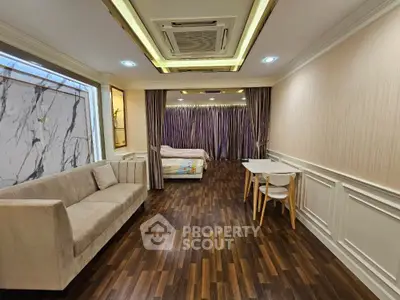 Luxurious studio apartment with elegant wood flooring and modern furnishings