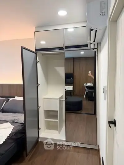 Modern bedroom with open wardrobe and sleek design