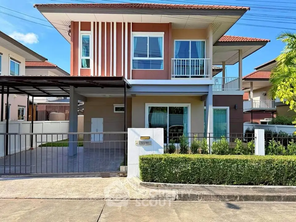Modern two-story house with carport and landscaped front yard in a suburban neighborhood.