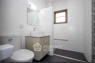 Modern bathroom with sleek white tiles and contemporary fixtures