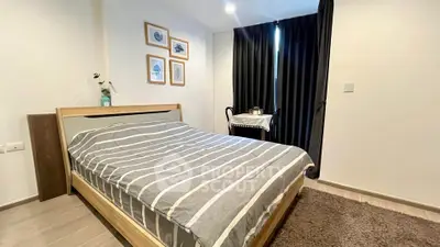 Cozy bedroom with modern decor and natural light, perfect for relaxation.