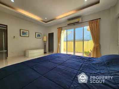 Spacious bedroom with balcony access and modern decor