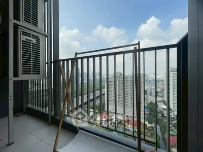 Stunning cityscape view from a high-rise balcony with modern railing.