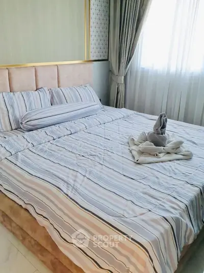 Luxurious bedroom with elegant decor and plush bedding in a modern apartment.