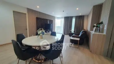 Spacious modern living room with elegant dining area and large windows.