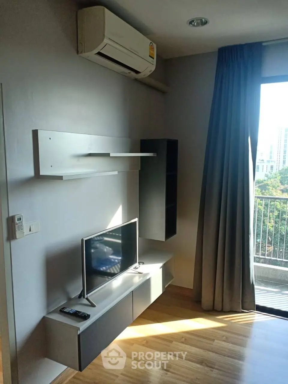 Modern living room with air conditioning and balcony view in urban apartment