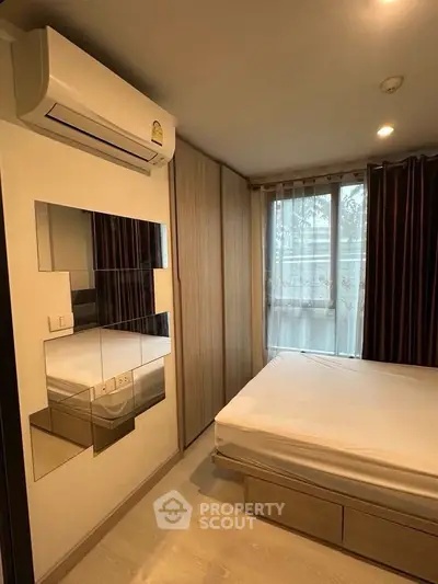 Cozy bedroom with modern air conditioning and stylish mirrored wall accents