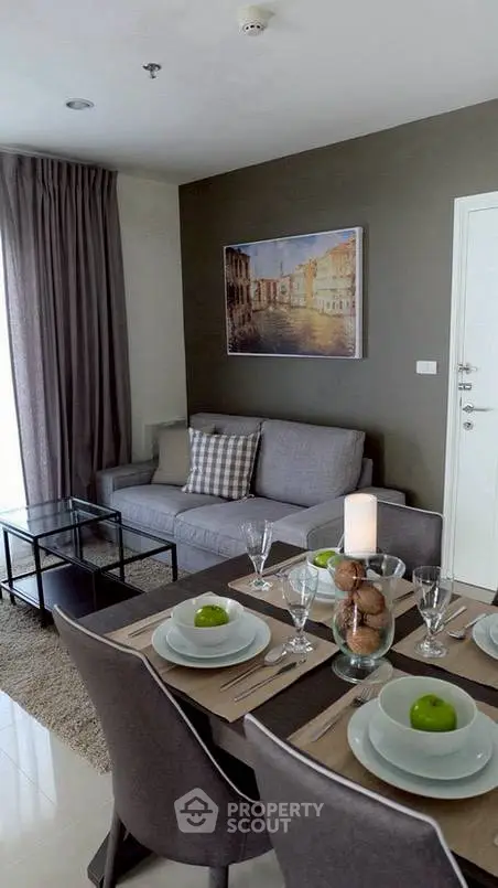 Modern living room with dining area, stylish decor, and natural light.