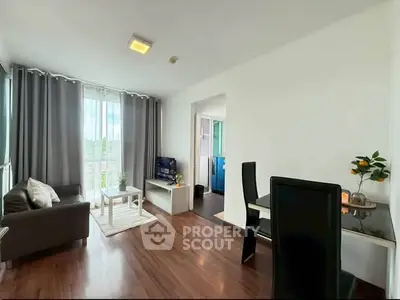 Modern living room with sleek furniture and natural light in a stylish apartment.
