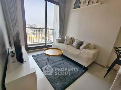 Modern living room with city view, cozy sofa, and stylish decor