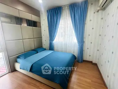 Cozy bedroom with stylish decor and blue accents, perfect for relaxation and comfort.