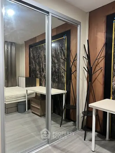 Modern bedroom with mirrored closet and stylish decor