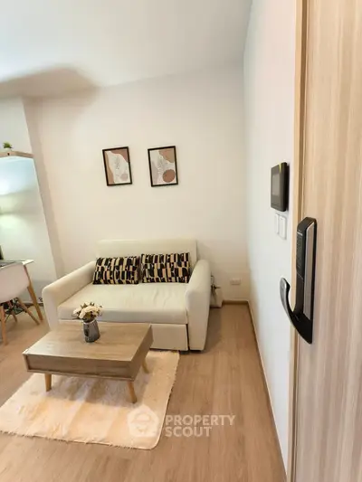 Cozy living room with modern decor and comfortable seating in a stylish apartment.