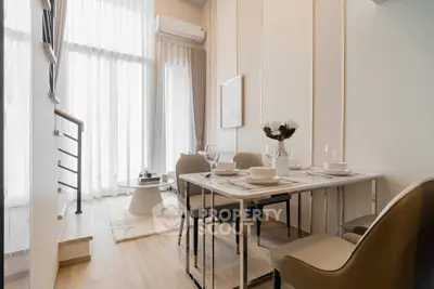 Modern dining area with elegant table setting and natural light