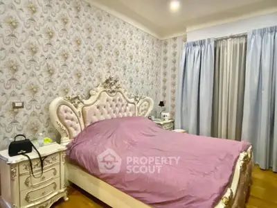 Luxurious bedroom with ornate bed and elegant wallpaper, perfect for sophisticated living.