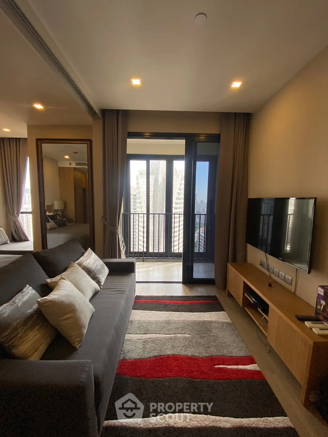 Modern living room with balcony view in high-rise apartment