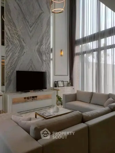 Luxurious living room with high ceilings and elegant decor