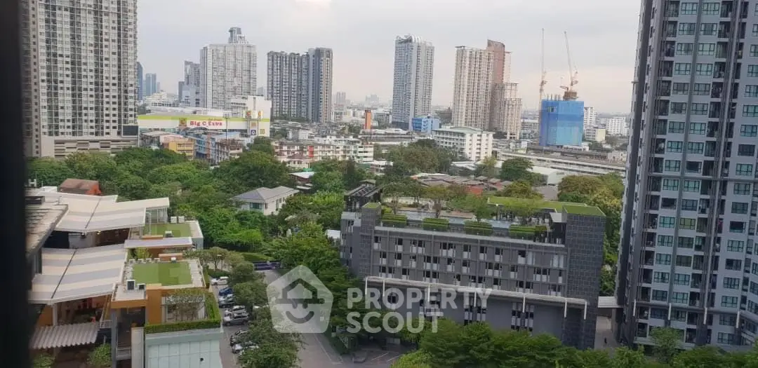 Stunning cityscape view from a high-rise building with lush greenery and modern architecture.